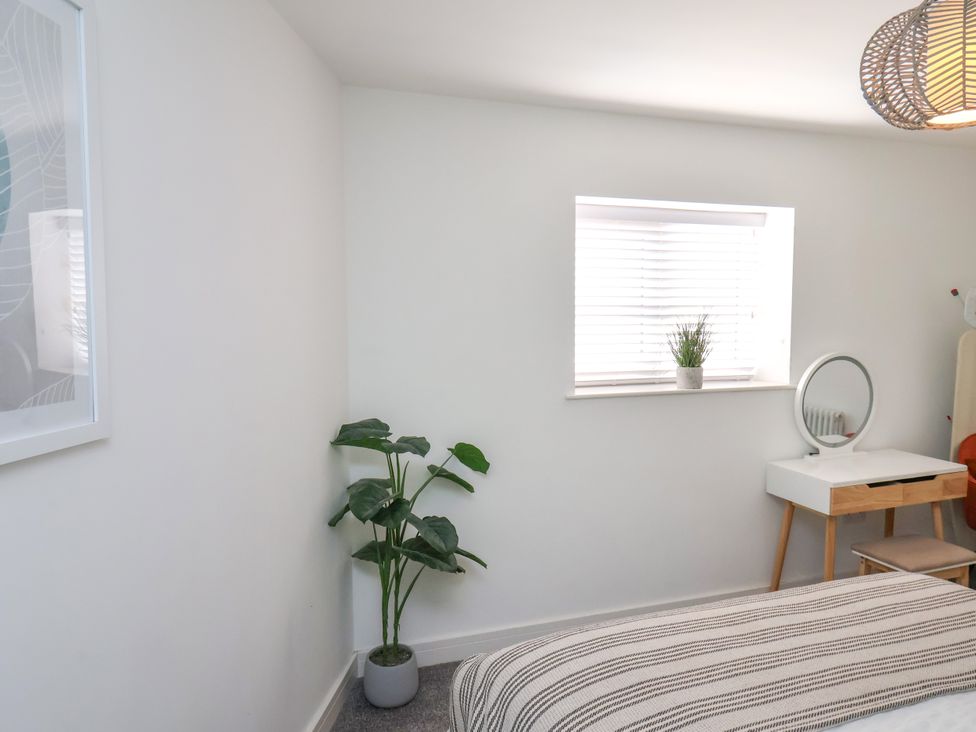 A bedroom with a plant and a desk at Apartment 3 (2 bed) in Redcar