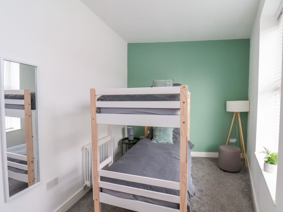 A bedroom with a bunk bed and a lamp at Apartment 3 ( 2 bed ) in Redcar