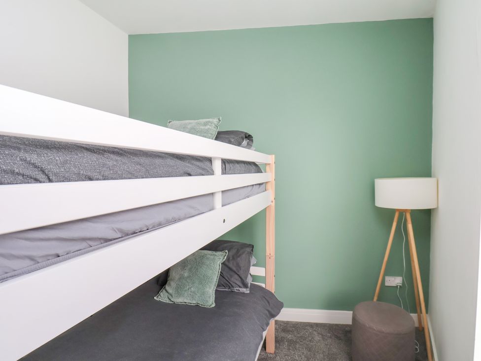 A bedroom with a bunk bed and a lamp at Apartment 3 (2 bed) Redcar