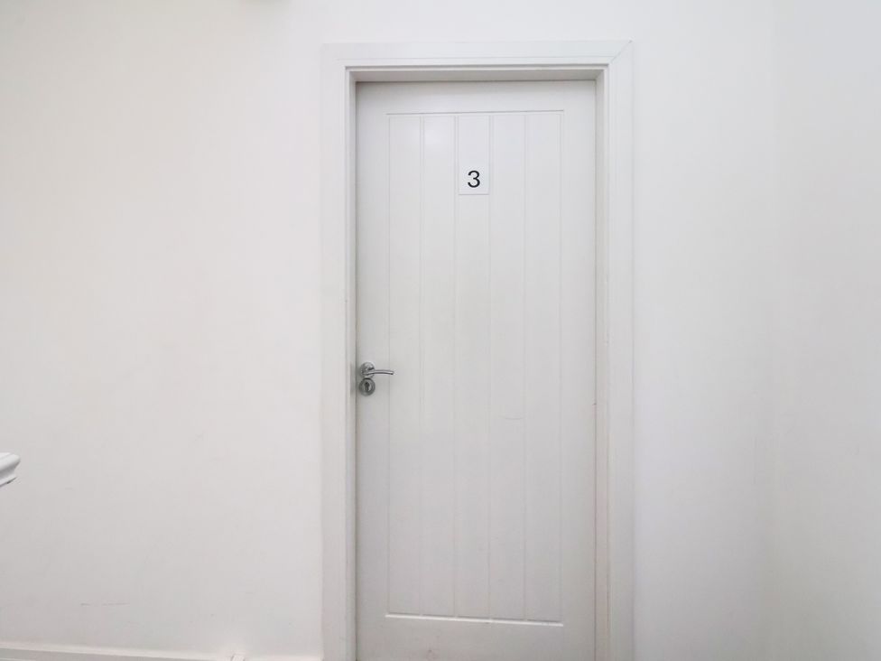 A door with number 3 in a hallway at Apartment 3 (2 bed) Redcar