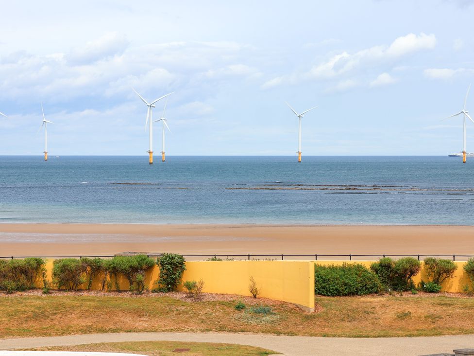 A view of wind turbines in the sea from a beach at Apartment 3 (2 bed) in Redcar