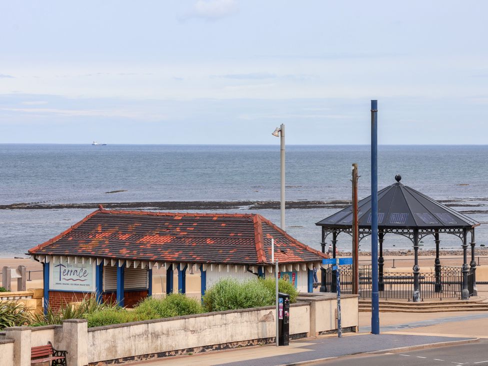 A beach scene with a kiosk and gazebo at Apartment 3 (2 bed) in Redcar