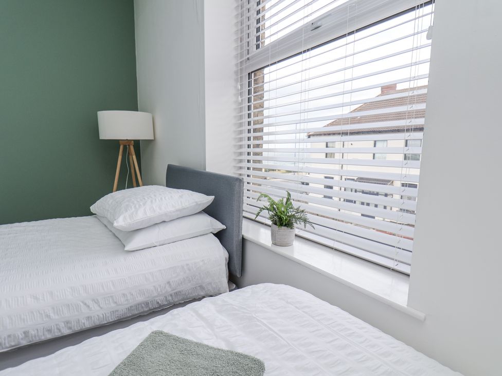 A bedroom with two beds and a lamp at Glenholme Apartment 3 Redcar