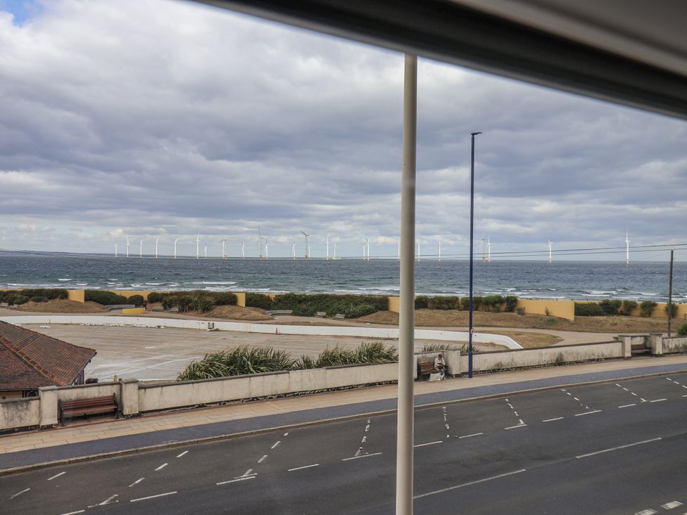 A view of the ocean with wind turbines in the distance at Glenholme Apartment 3 Redcar