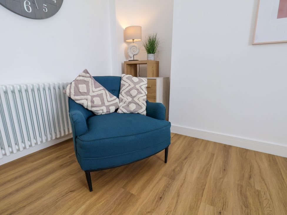 A living room with an armchair and a side table at Apartment 4 (1 bed) in Redcar