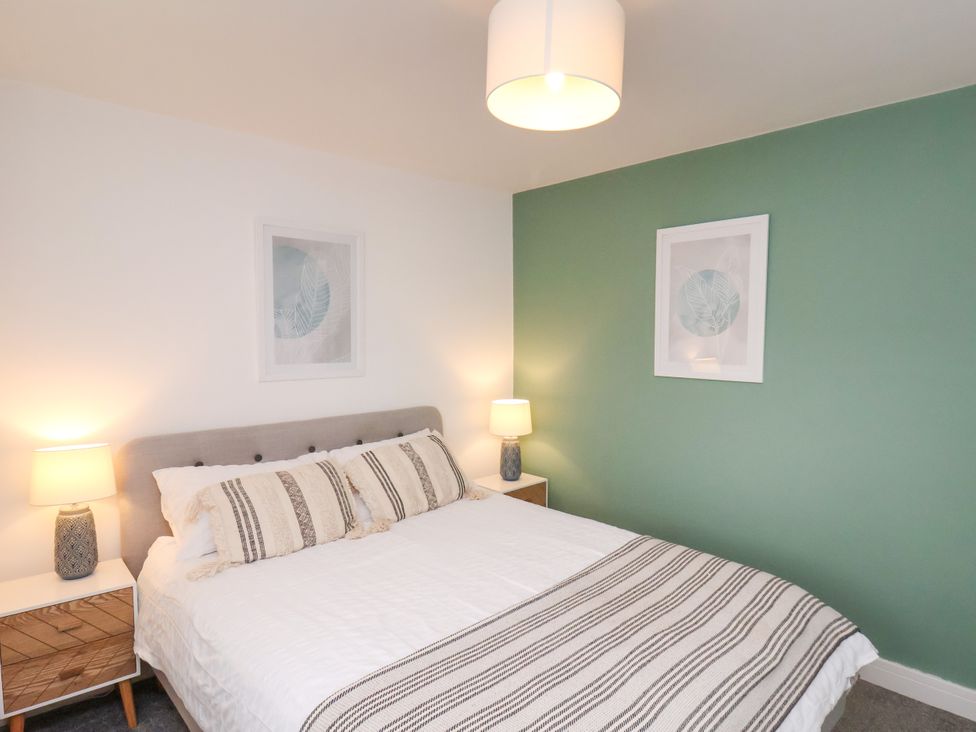 A bedroom with a bed and bedside tables at Apartment 4 ( 1 bed ) Redcar
