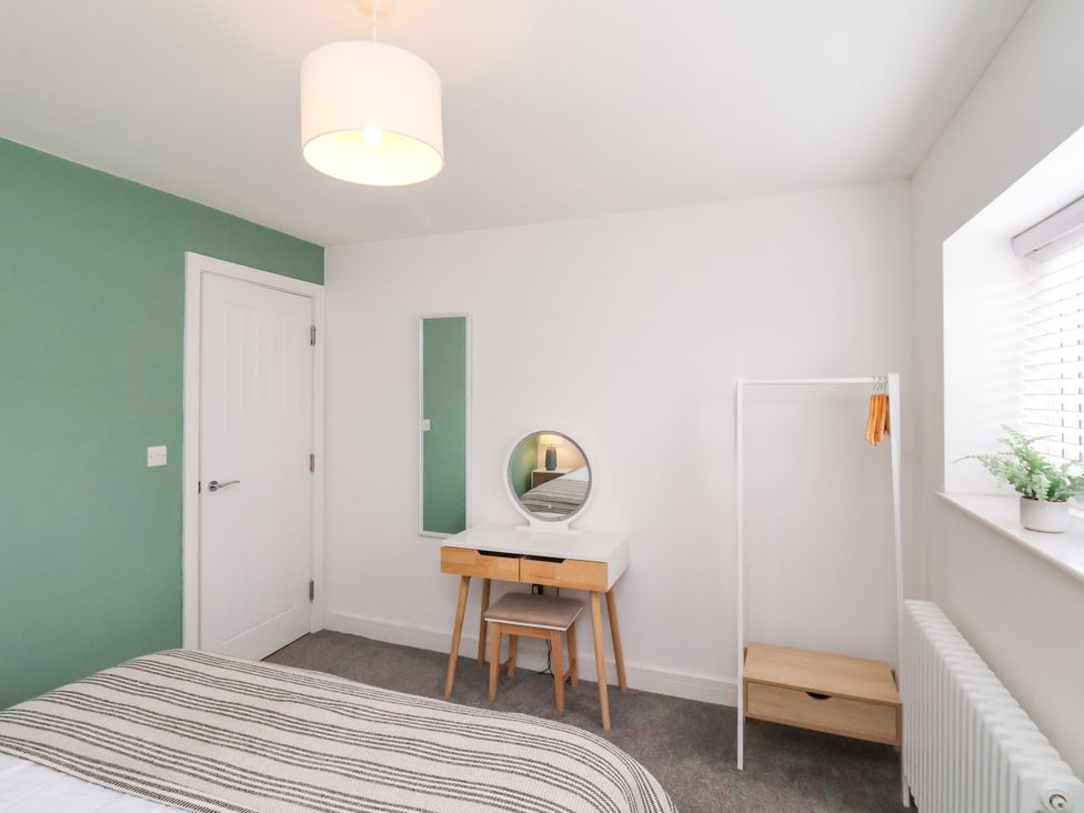 A bedroom with a bed and dresser at Apartment 4 ( 1 bed ) in Redcar