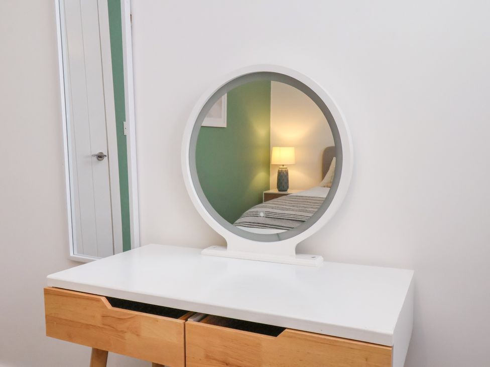 A table with a mirror in a bedroom at Apartment 4 ( 1 bed ) in Redcar