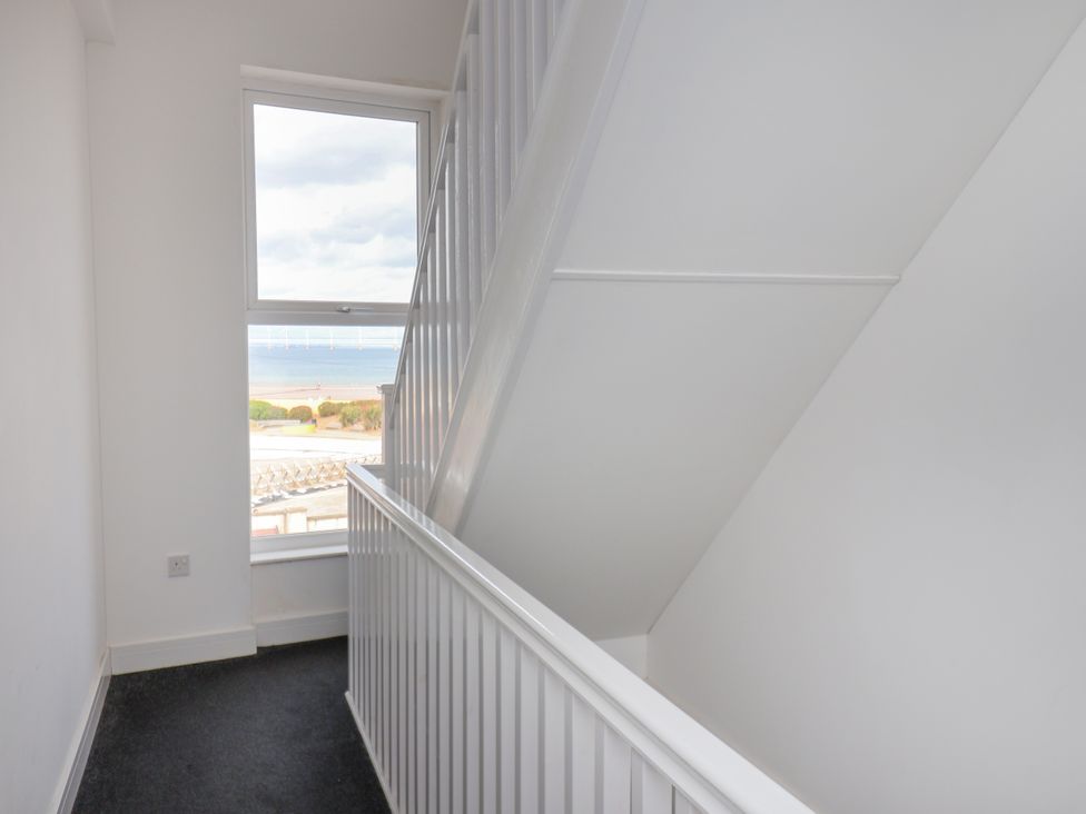 A staircase with a window overlooking the outdoors at Apartment 4 ( 1 bed ) Redcar