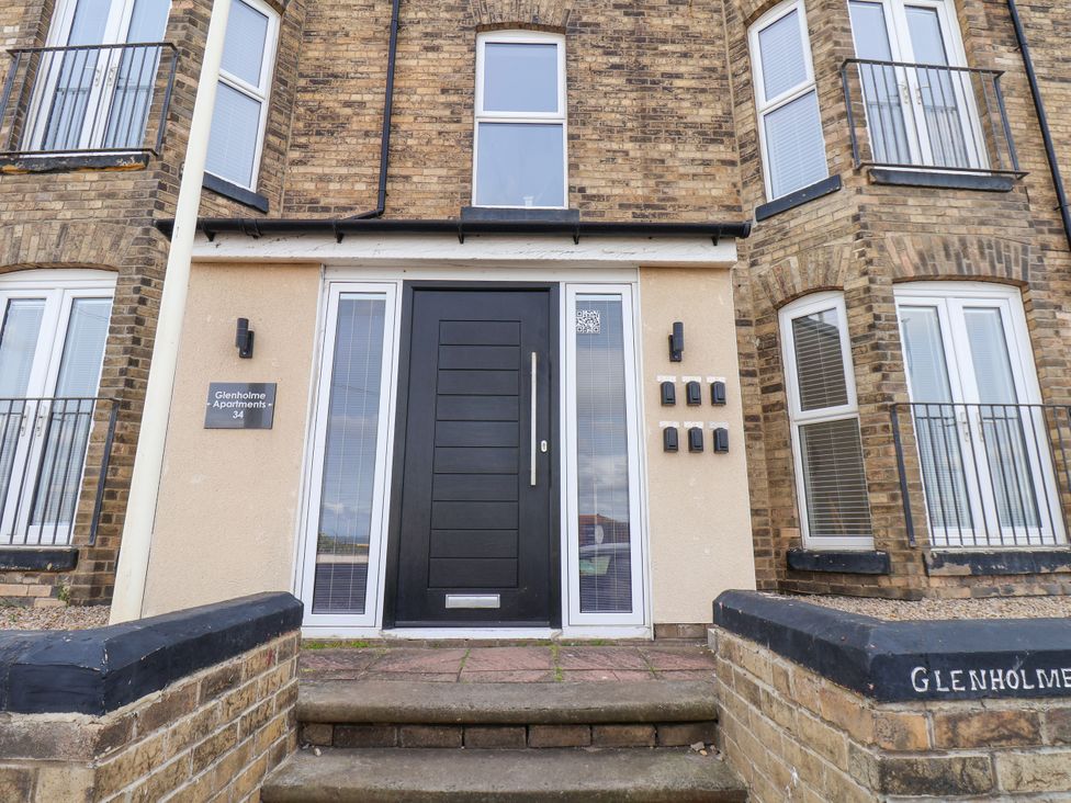 A front entrance with a black door and mailboxes at Glenholme Apartments in Redcar