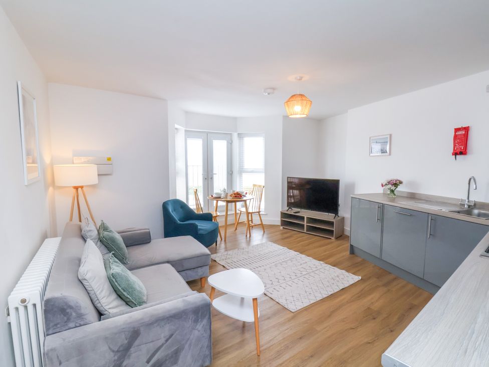 A living room with a sofa and a table at Apartment 5 (1 bed) Redcar