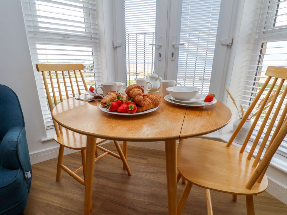 A dining room table with croissants and strawberries at Apartment 5 ( 1 bed ) Redcar