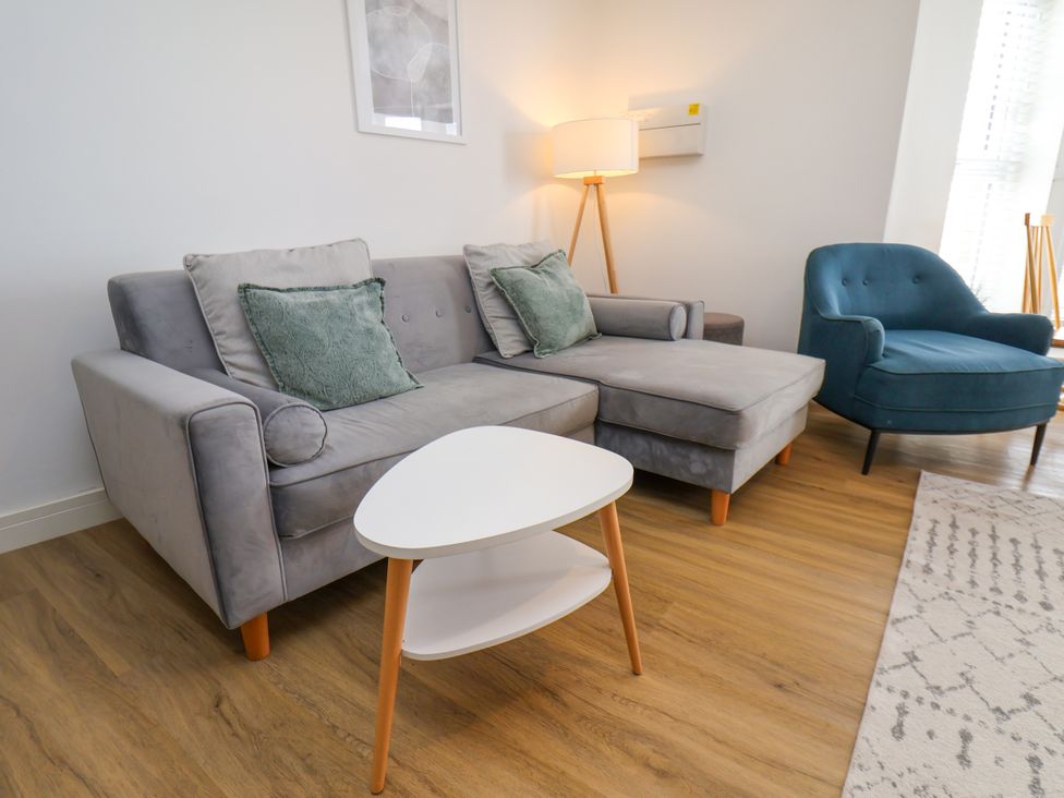 A living room with a sofa, chair, and coffee table at Apartment 5 (1 bed) Redcar