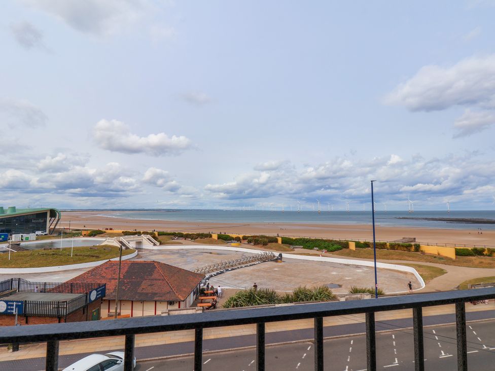 A beach view with a pathway and wind turbines at Apartment 5 (1 bed) in Redcar