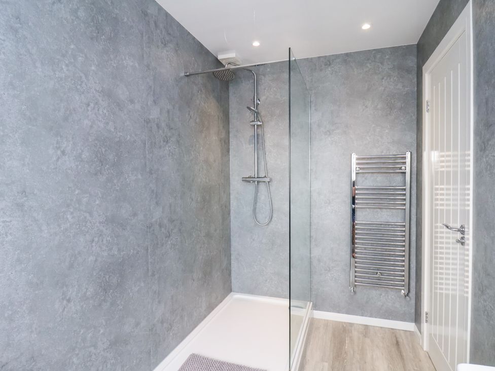 A bathroom with a shower and towel rail at Apartment 5 (1 bed) Redcar