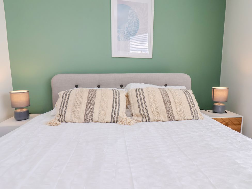 A bedroom with a bed and lamps at Apartment 5 ( 1 bed ) in Redcar