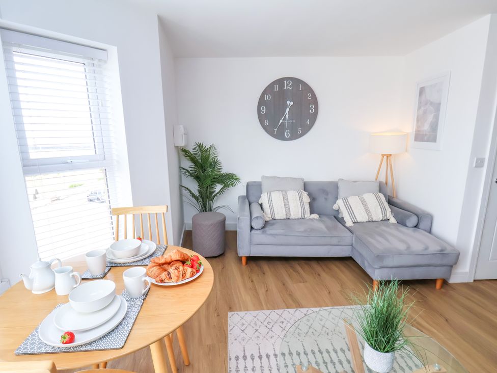 A living room with a sofa and dining table at Apartment 6 (1 bed) in Redcar