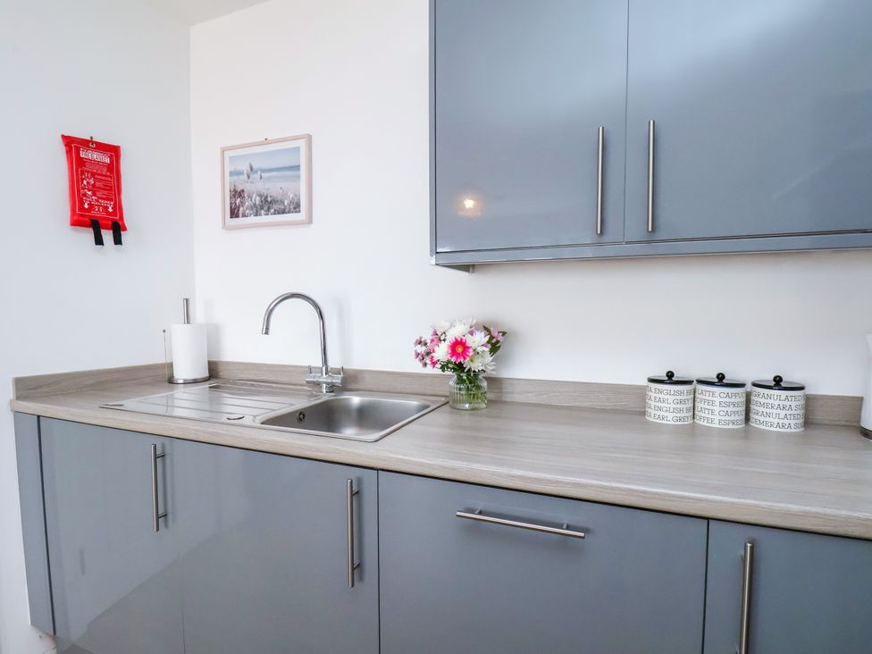 A kitchen with a sink and cabinets at Apartment 6 (1 bed) in Redcar