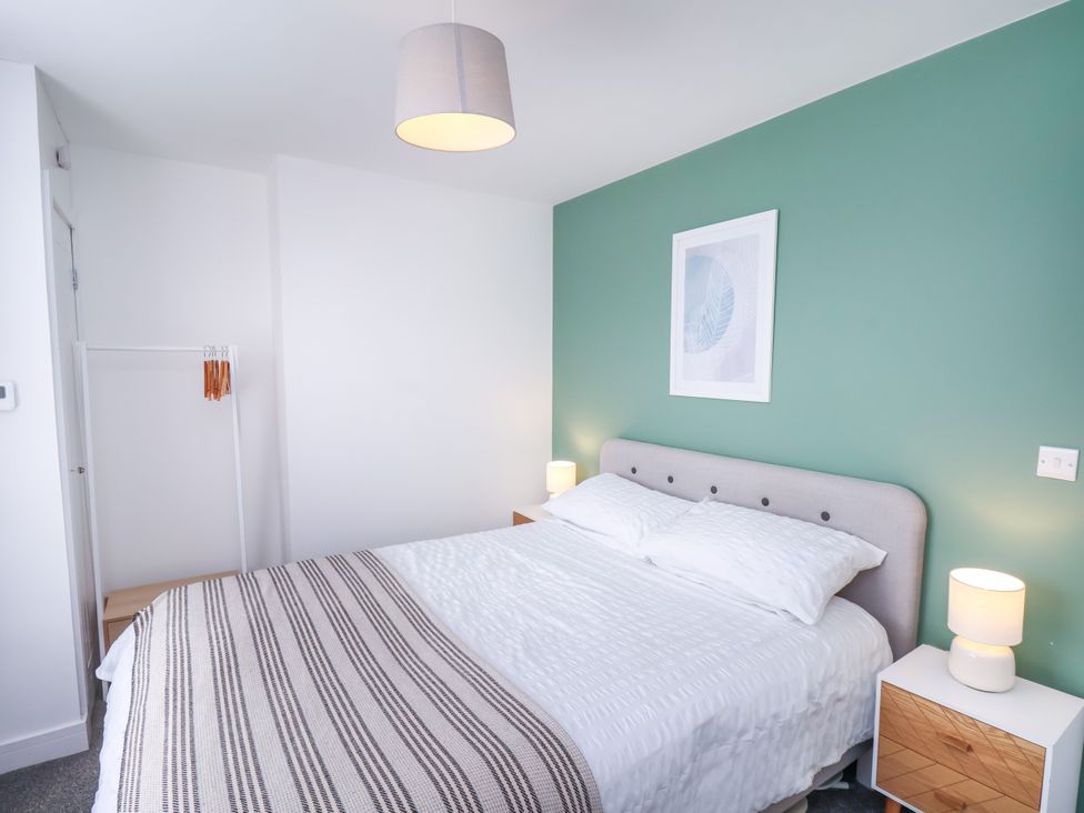 A bedroom with a bed and lamp at Apartment 6 (1 bed) in Redcar