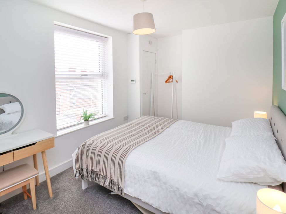 A bedroom with a bed and desk at Apartment 6 ( 1 bed ) in Redcar