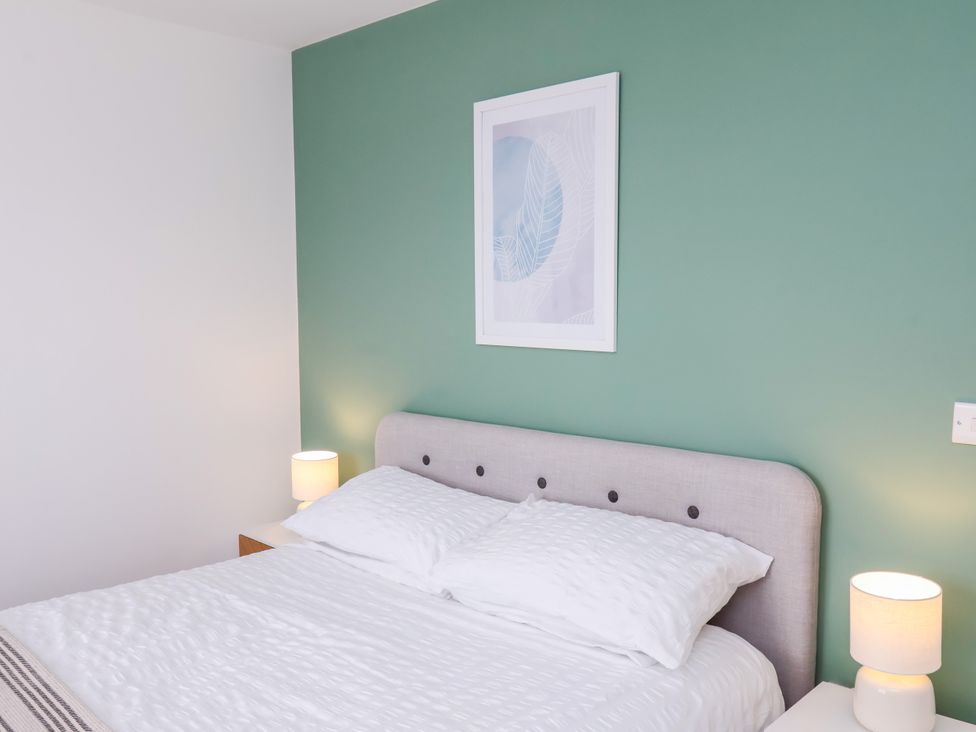 A bedroom with a bed and bedside lamps at Apartment 6 (1 bed) in Redcar