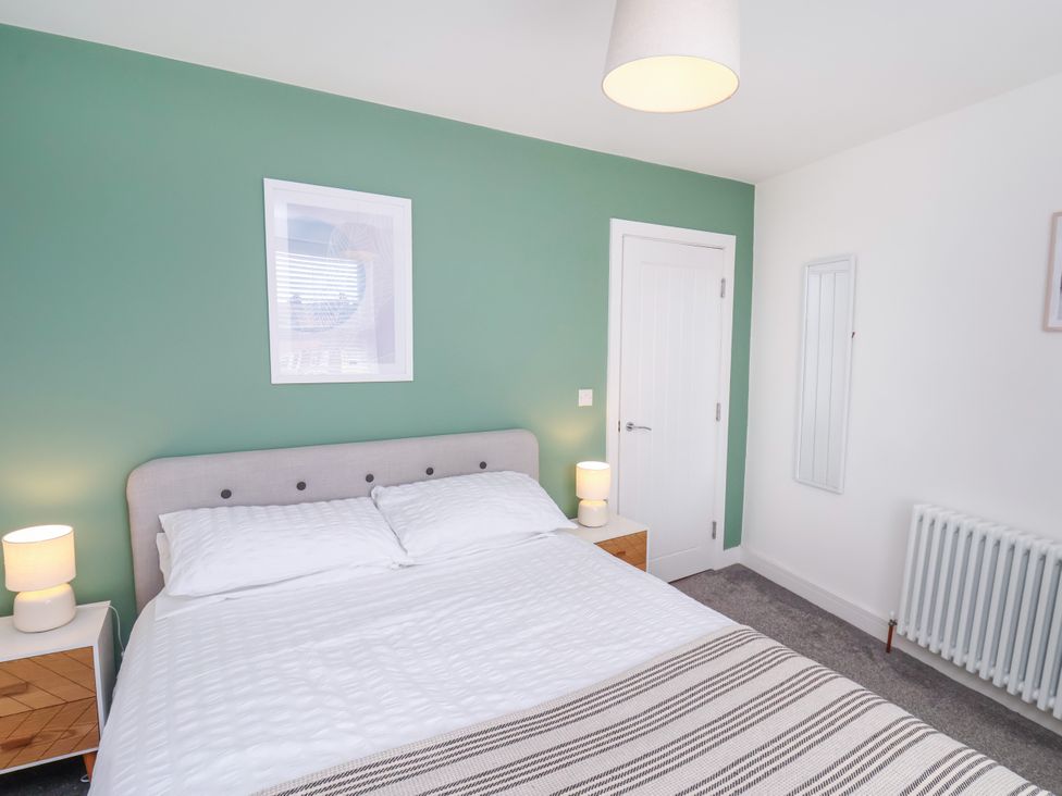 A bedroom with a bed and bedside lamp at Apartment 6 ( 1 bed ) Redcar