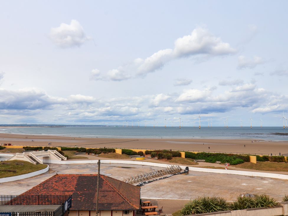 A view of the beach and water with wind turbines at Apartment 6 ( 1 bed ) in Redcar