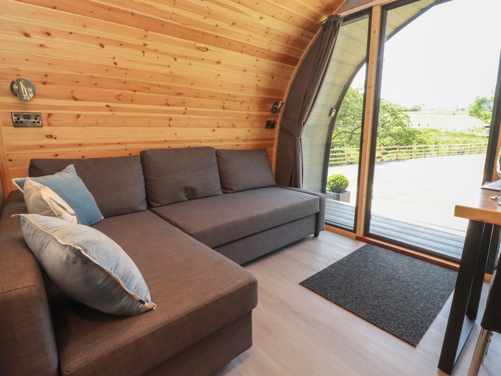 A snug with a couch and large window at Barley near Nelson