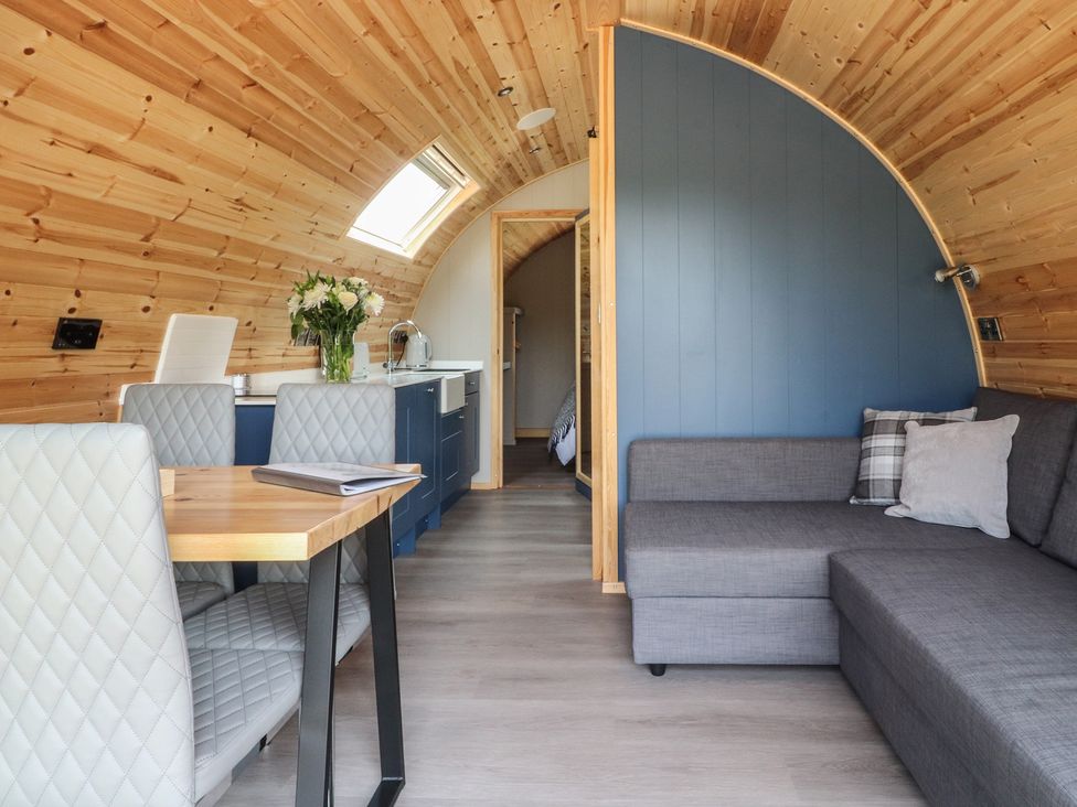 A living room with a table and chairs at Black Moss in Nelson