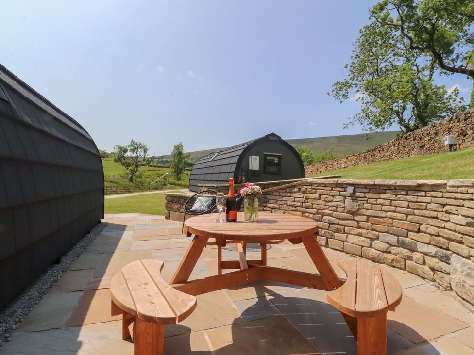 An outdoor seating area with a table and chairs at Black Moss in Nelson