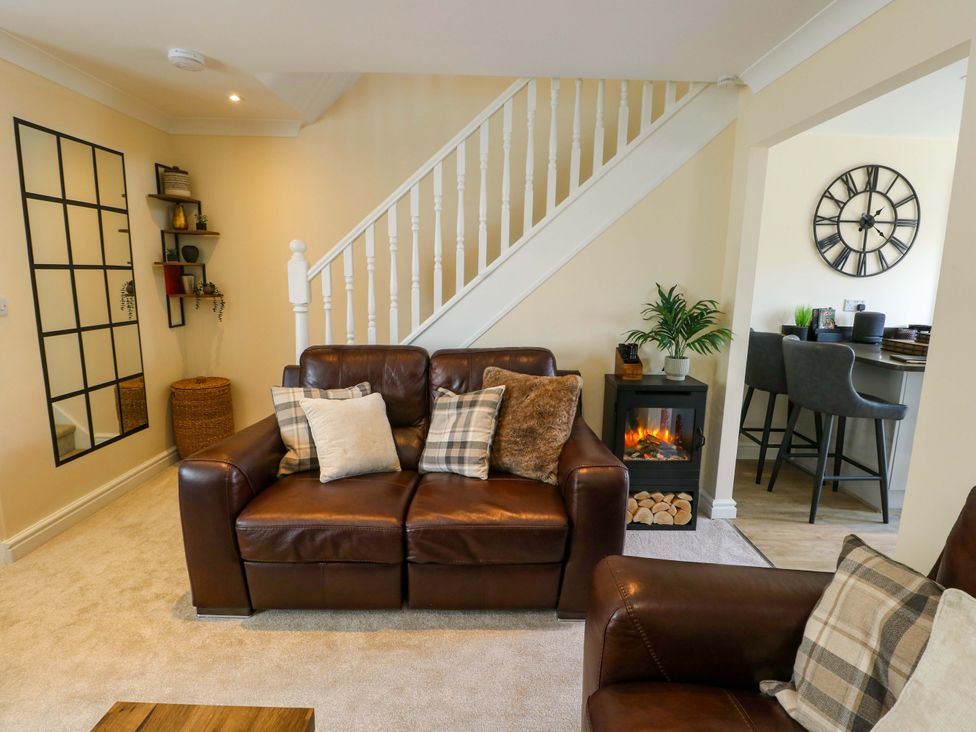 A living room with a sofa and fireplace at 20 Cysgod Y Bryn Rhos-On-Sea
