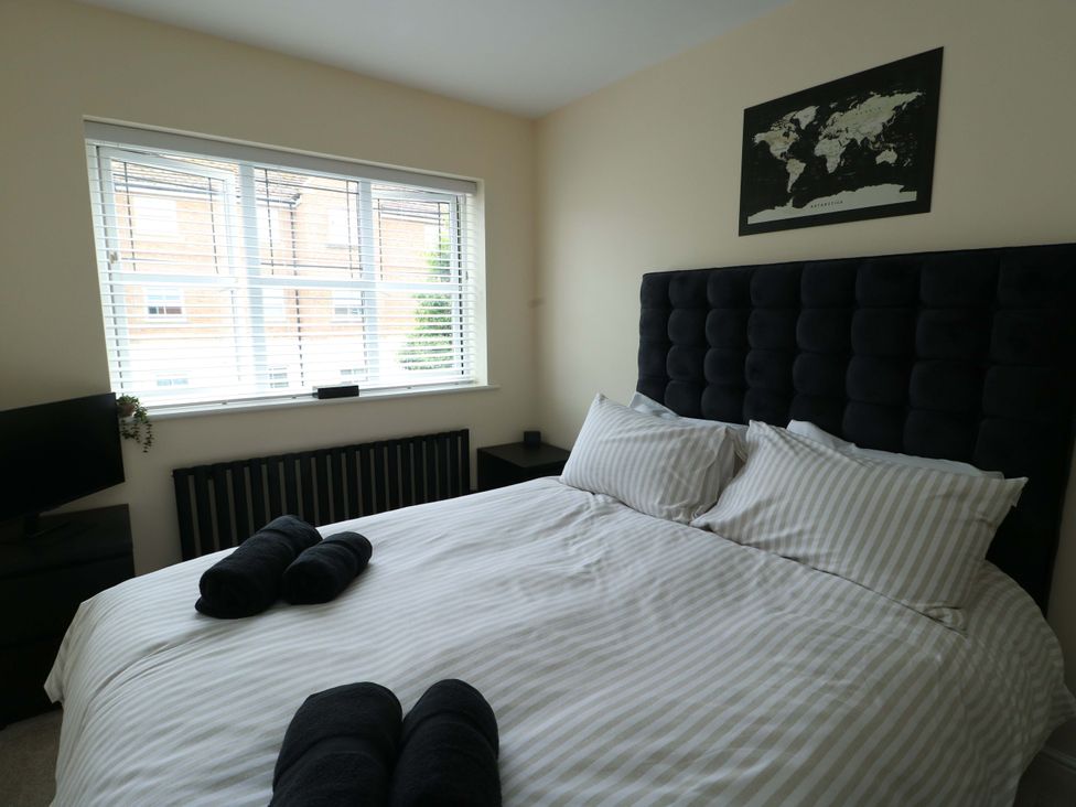 A bedroom with a bed and television at 20 Cysgod Y Bryn Rhos-On-Sea