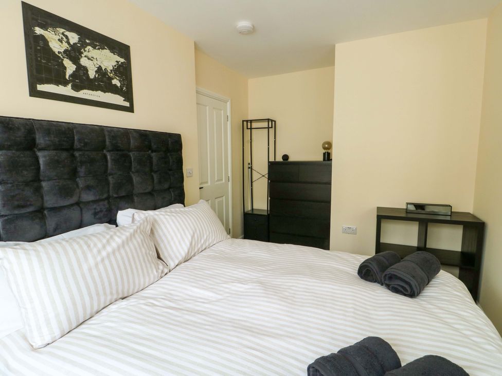 A bedroom with a bed and furniture at 20 Cysgod Y Bryn Rhos-On-Sea