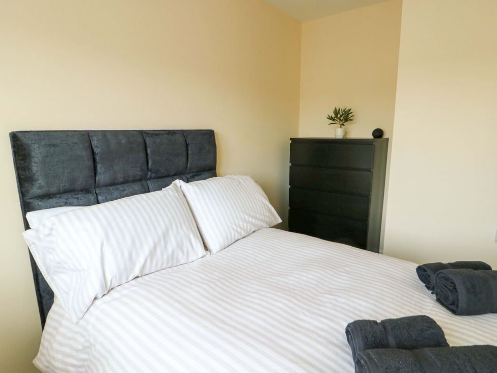 A bedroom with a bed and a chest of drawers at 20 Cysgod Y Bryn in Rhos-On-Sea