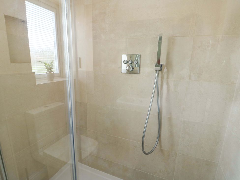 A shower area with glass door and shower controls at 20 Cysgod Y Bryn Rhos-On-Sea