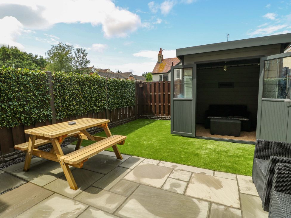 A garden with a picnic table and shed at 20 Cysgod Y Bryn Rhos-On-Sea