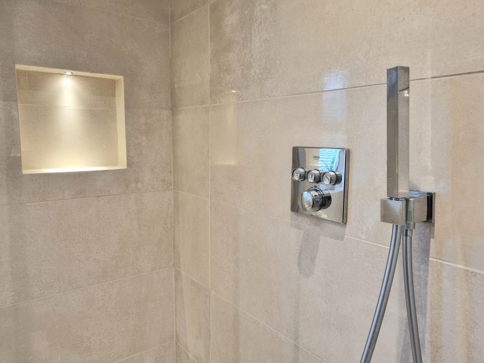 A shower with control panel and built-in niche at Hafan Rhos in Rhos-On-Sea
