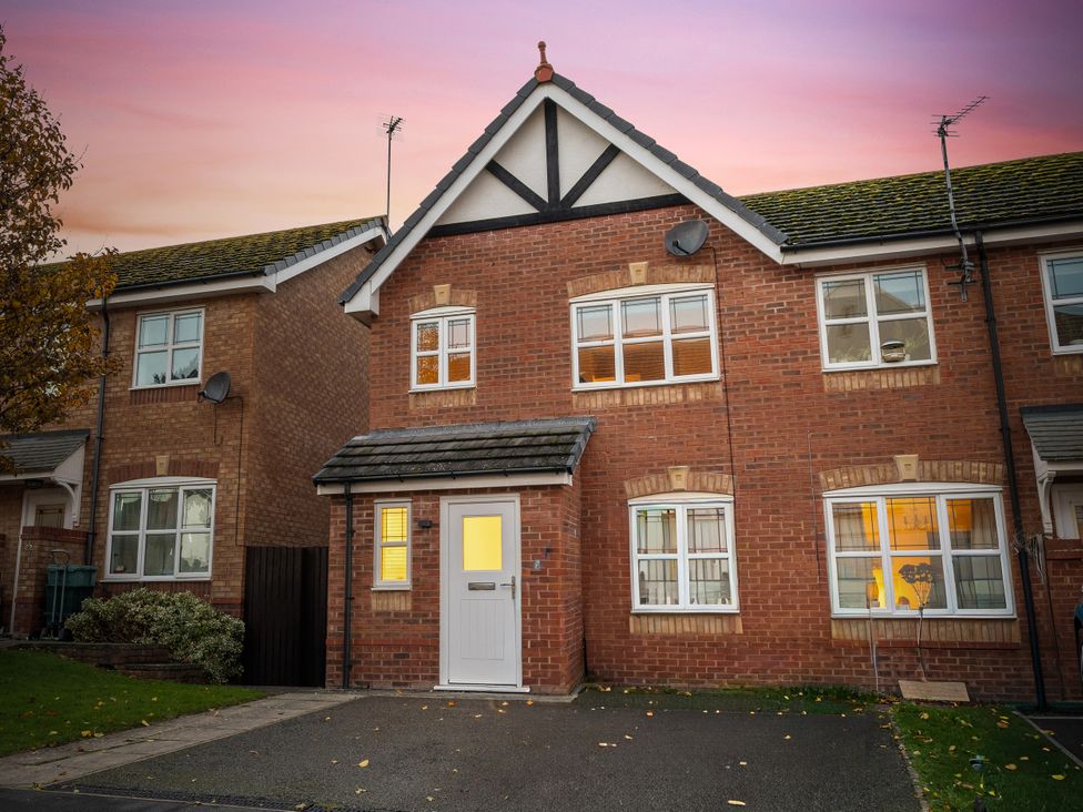 A house with brick exterior and front door at Hafan Rhos in Rhos-On-Sea