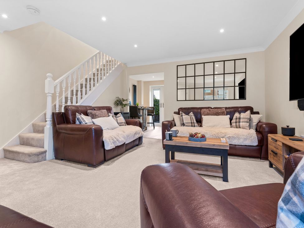 A living room with sofas and a coffee table at Hafan Rhos in Rhos-On-Sea