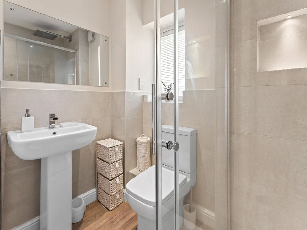 A bathroom with sink, toilet, and shower at Hafan Rhos, Rhos-On-Sea