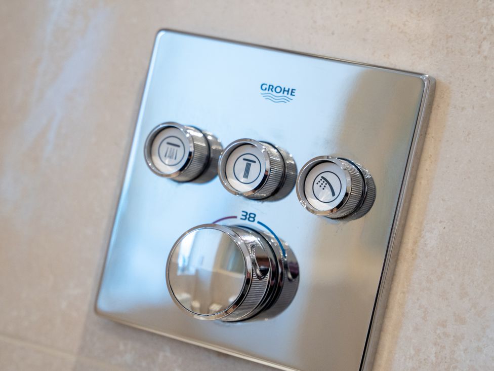 A shower control panel with temperature and flow controls at Hafan Rhos in Rhos-On-Sea