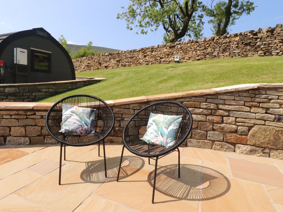 Two chairs with cushions in a garden area at Ogden in Nelson