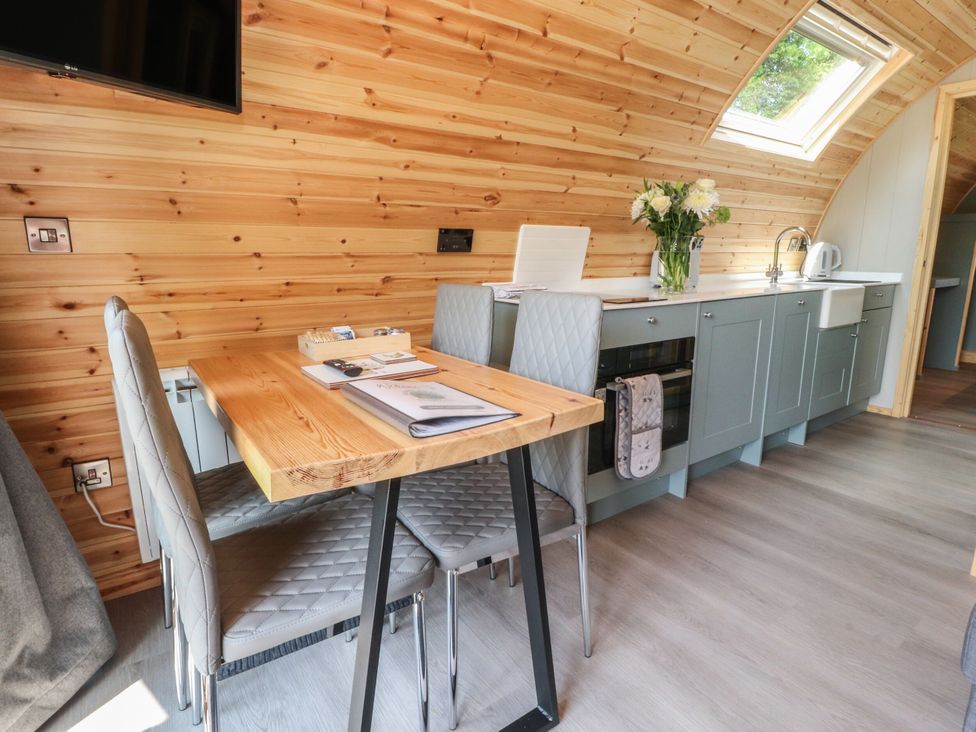 A kitchen with a table and chairs at Ogden in Nelson