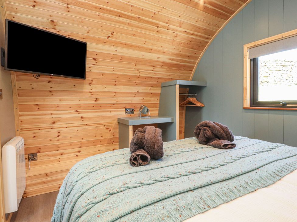 A bedroom with a bed and towels on top at Ogden in Nelson