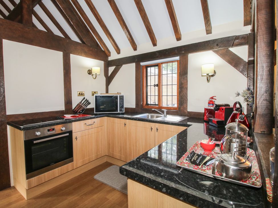 A kitchen with a sink and cabinets at The Coach House in Little Stretton