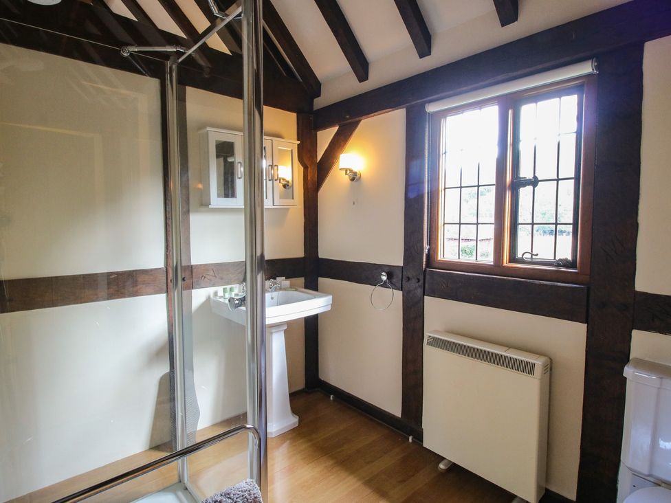A bathroom with a shower and sink at The Coach House Little Stretton