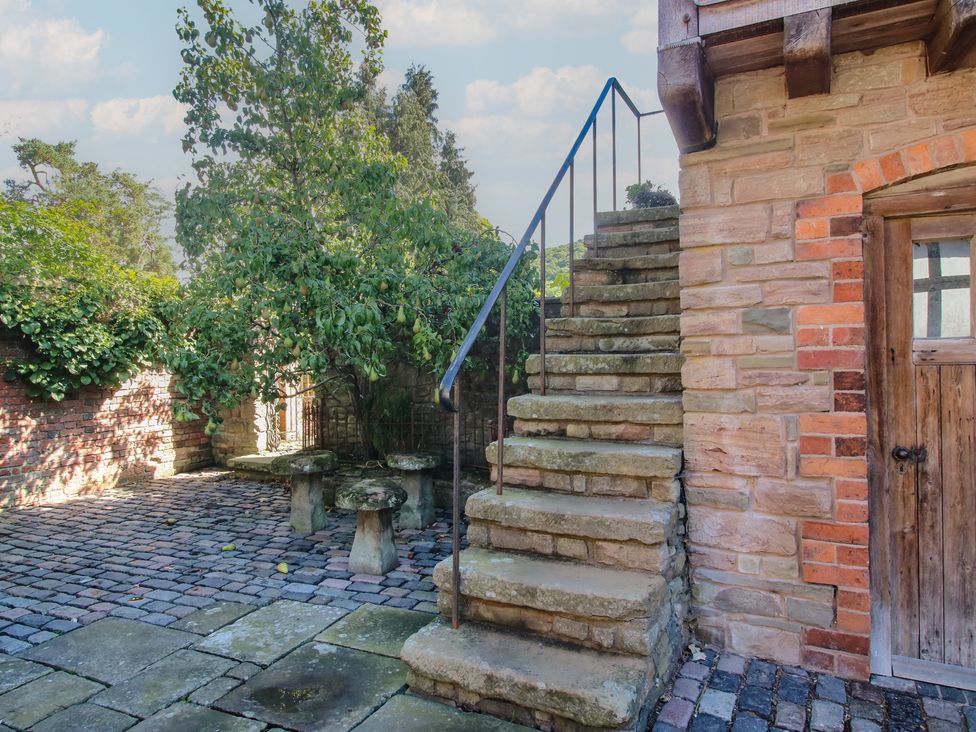 An outdoor area with stairs and stone seating at The Coach House in Little Stretton
