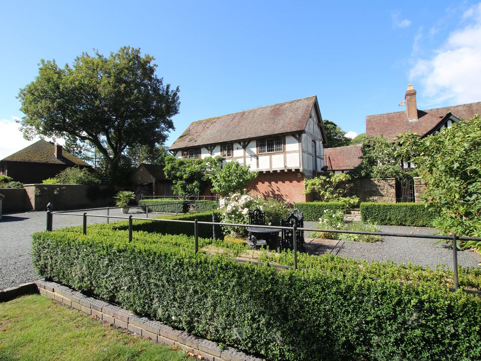 An outdoor view of a house and garden at The Coach House in Little Stretton