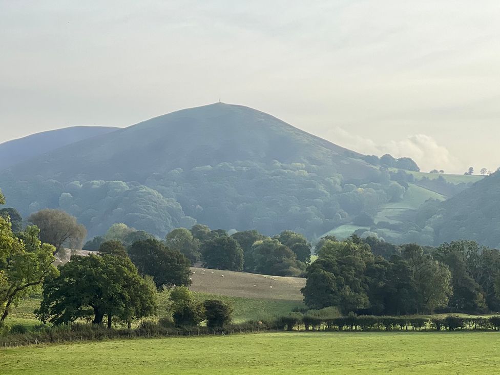 A landscape featuring mountains and trees at The Coach House in Little Stretton