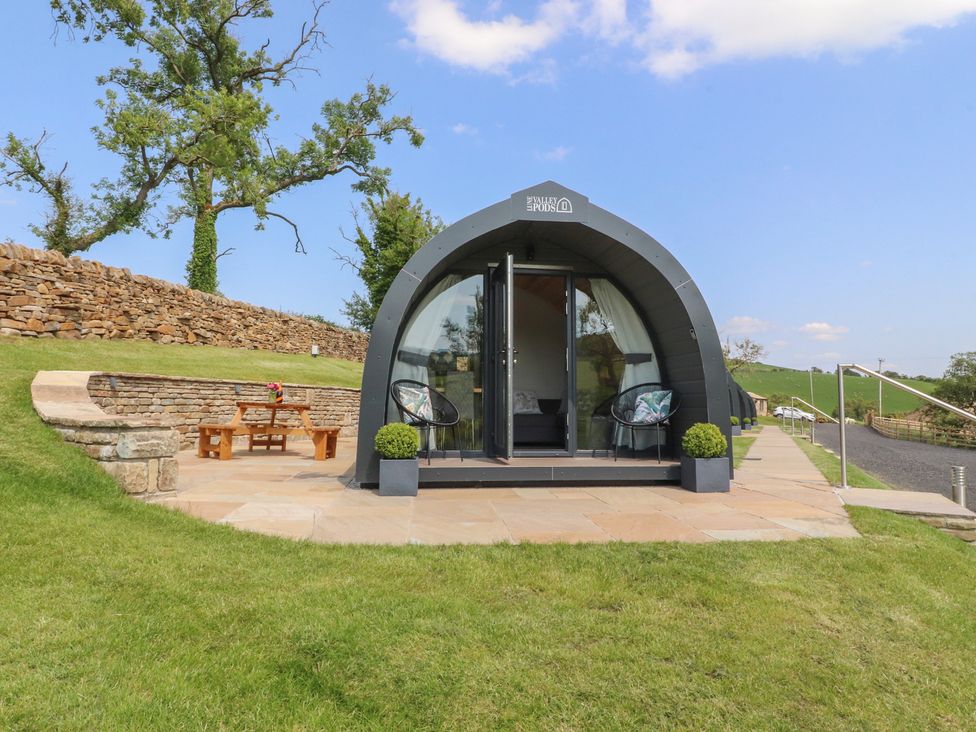 A glamping pod with outdoor seating at Pendle in Nelson
